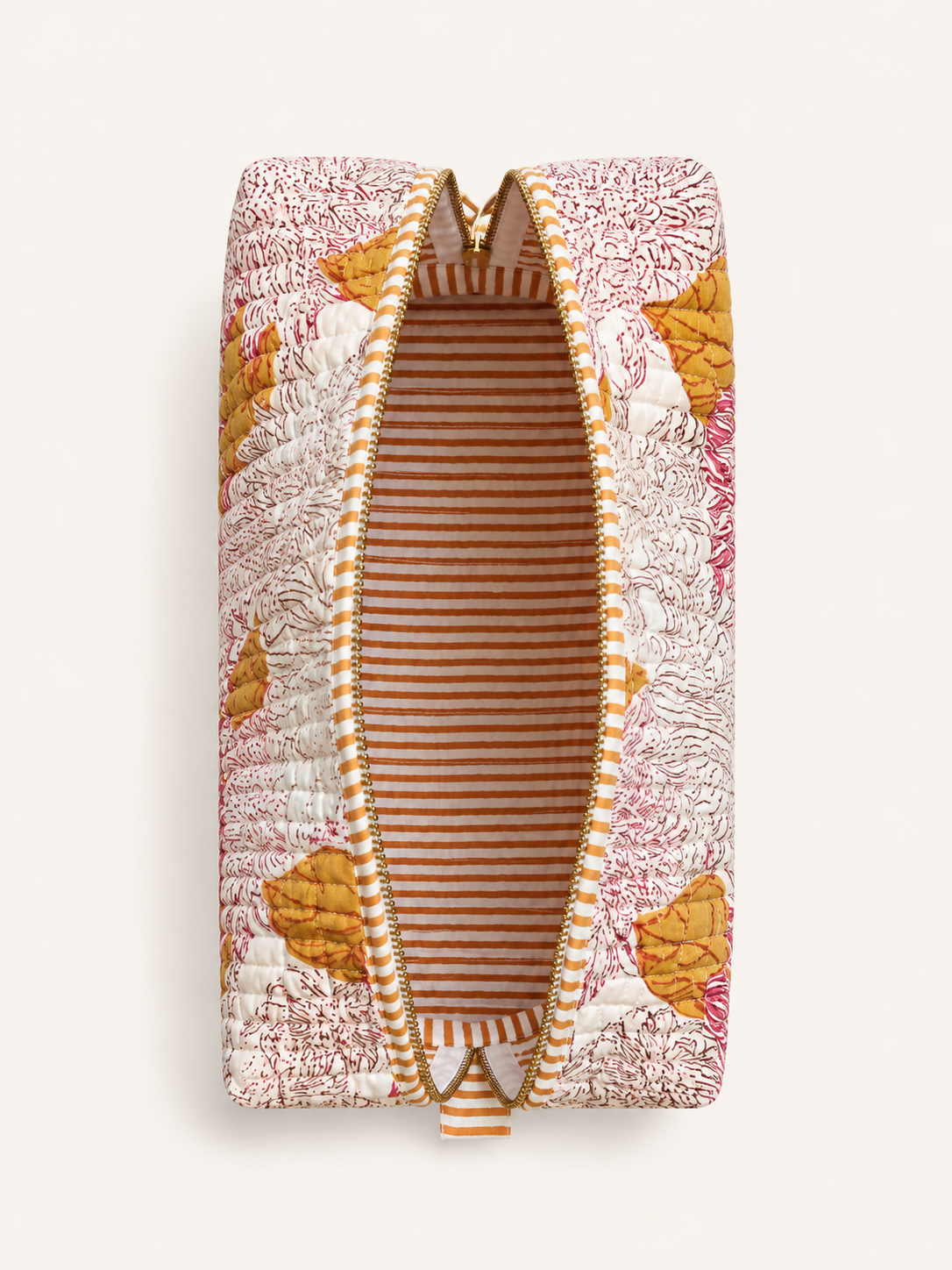 A quilted zippered pouch with a floral and leaf pattern in pink, orange, and white, featuring a striped interior lining, shown against a light beige background.