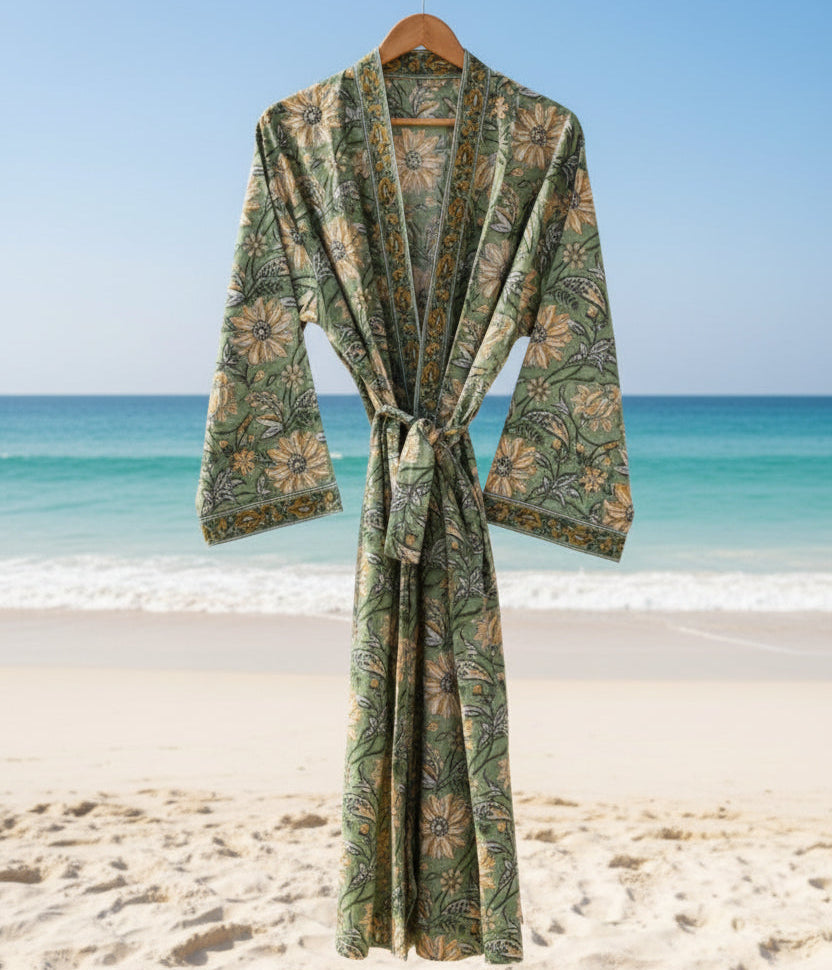 Green patterned robe against a beach backdrop with blue sky and ocean.