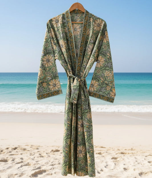 Green patterned robe against a beach backdrop with blue sky and ocean.