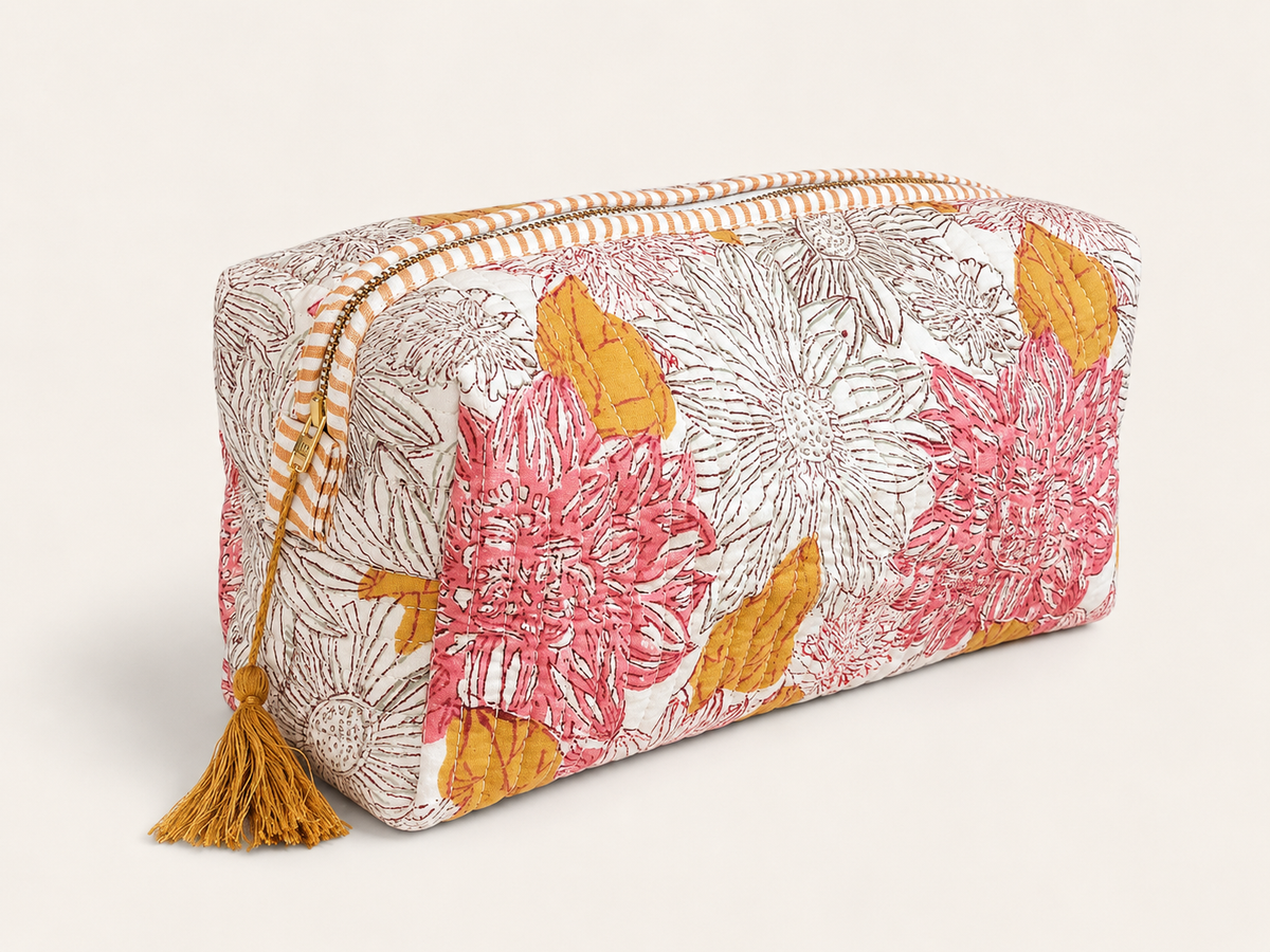 A rectangular zippered pouch with a white background and a colorful floral print featuring pink, orange flowers, finished with a matching tassel zipper pull.