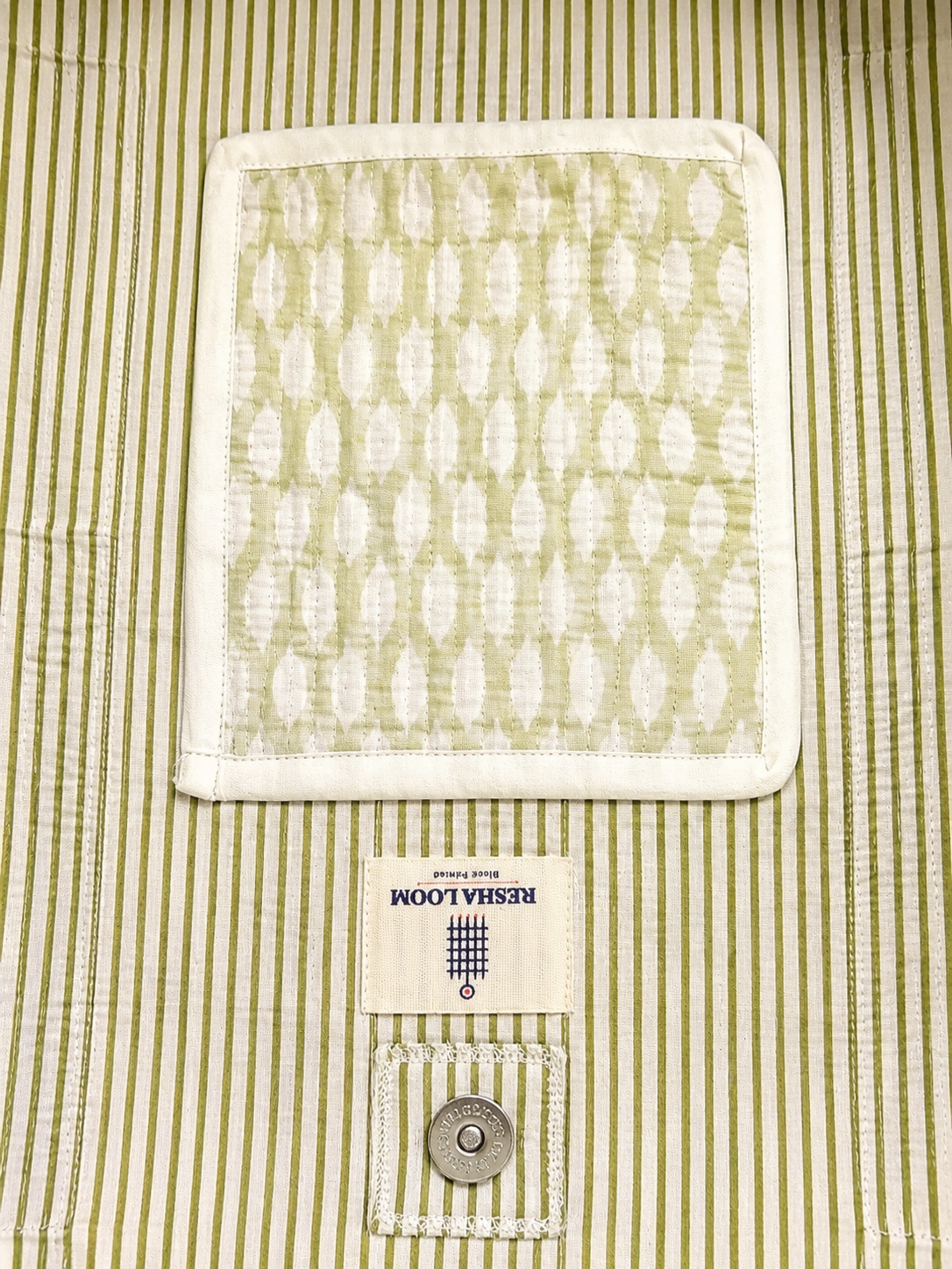 Close-up of a quilted tote bag showing inside of bag with olive green stripes 