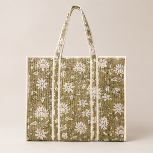 A large tote bag with a vertical quilted panel design, featuring an olive green and white floral pattern.