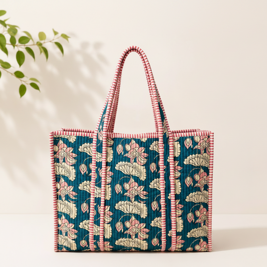 A woven tote bag with a teal blue floral pattern, pink and cream striped handles and trim, and a pink-and-white striped base.